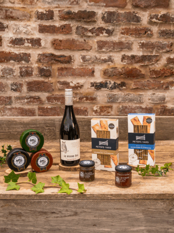 items from a cheese and wine hamper on a table at Rhug estate in North Wales