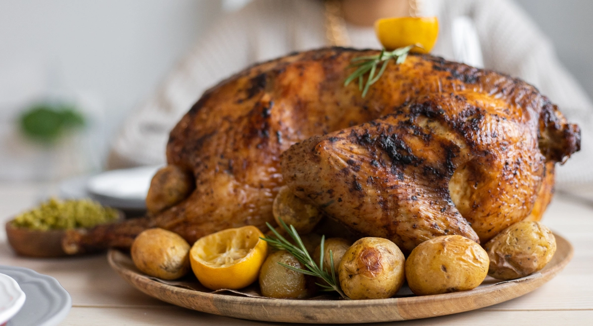 A roasted whole turkey on a wooden platter