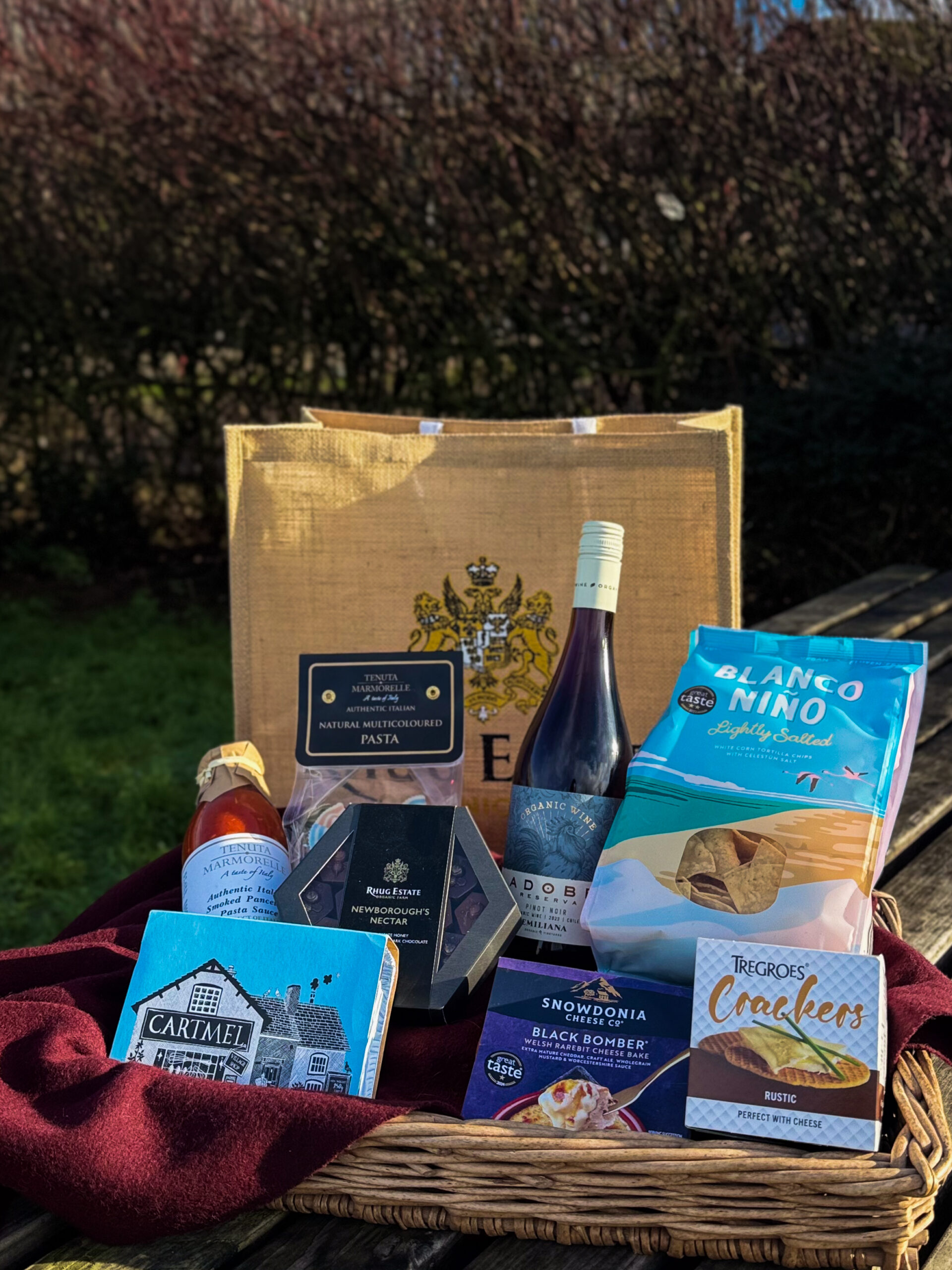 Valentines hamper Valentines hamper - containing, authentic Italian smoked pancetta pasta sauce, authentic Italian multicolour pasta, adobe pinot noir, Newborough's Nectar chocolates, blanco mini slightly salted tortilla chips, Cartmels sticky chocolate pudding, snowdonia cheese black bomber Welsh rarebit cheese bake, regrows rustic crackers. and a large Rhug Estate hessian bag